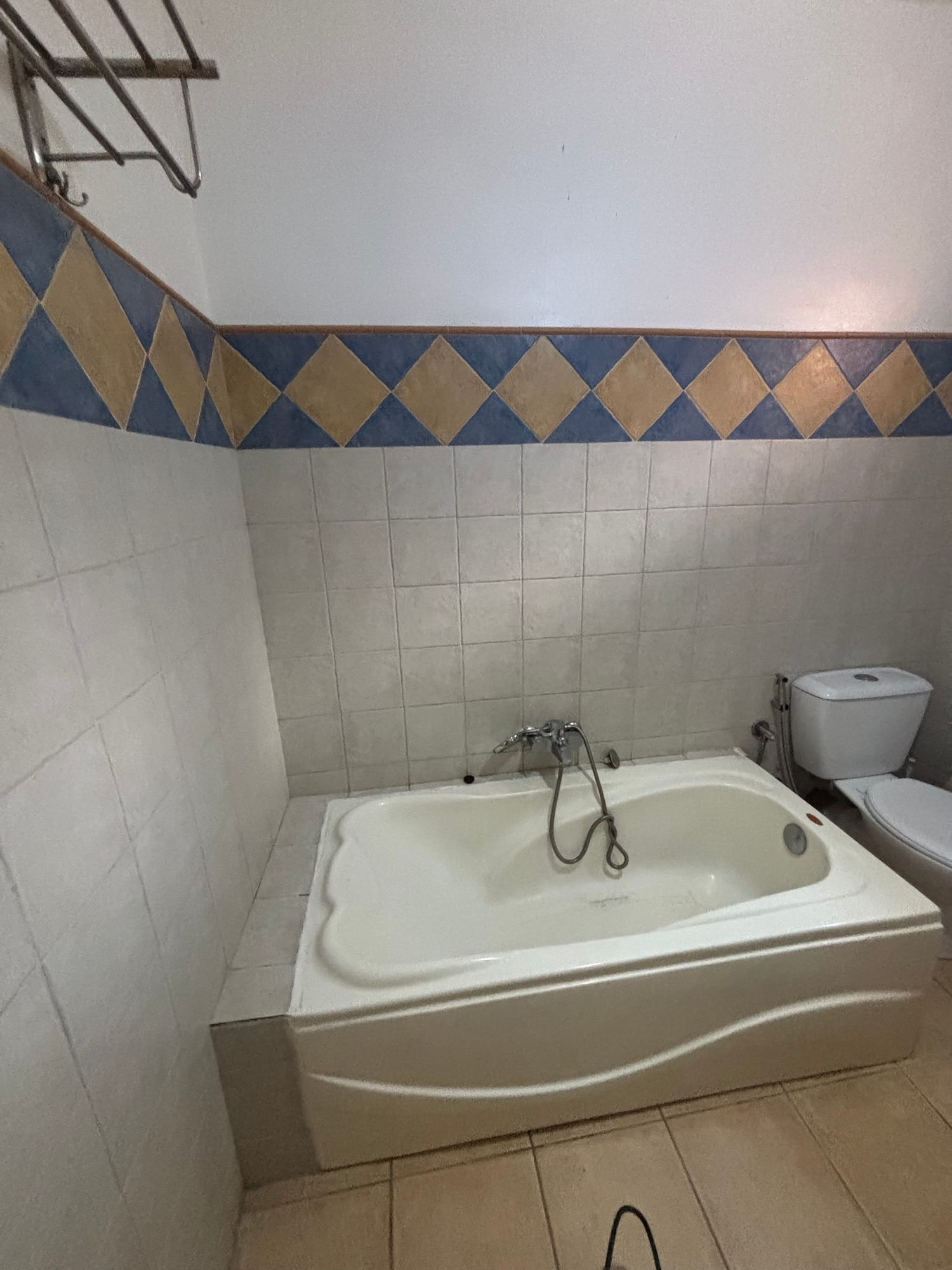 Finished bathroom with tiled walls and bathtub, renovated by Maurenov in Mauritius
