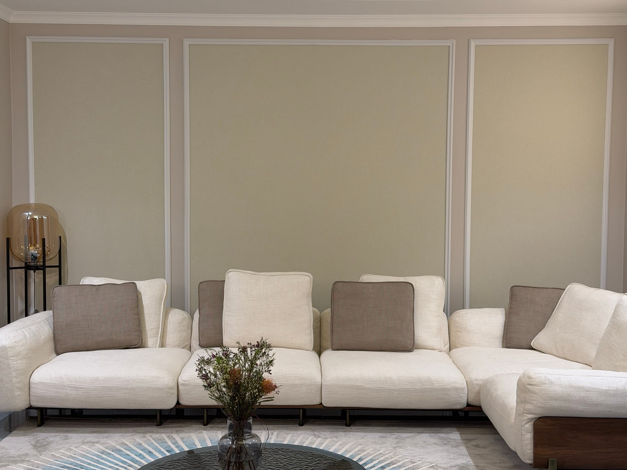 Living room with decorative wall panel trim and a sectional sofa, finished by Maurenov in Mauritius
